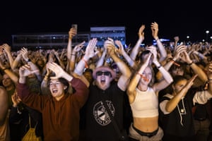 Crowds of people dancing to a DJ at a festival