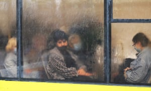 People wearing face masks as a preventive measure sit in a bus on rainy day in Kiev, Ukraine, 27 Sep 2020