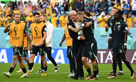 The Australia manager, Graham Arnold, congratulates his players after the win against Tunisia