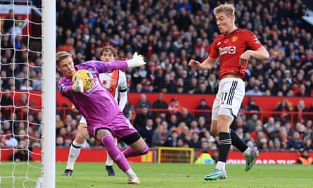 Luton Town goalkeeper Thomas Kaminski saves from Rasmus Højlund of Manchester United