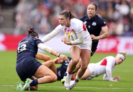 Helena Rowland of England is tackled by Lisa Thomson of Scotland