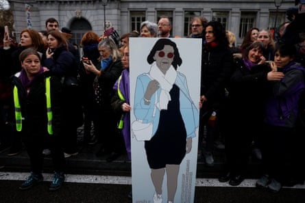 Celebrations and protests in the US and around the world mark International Women’s Day Woman holding sign