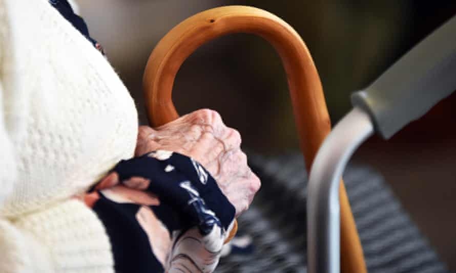 Close up of elderly lady's hand holding her walking stick in a care home