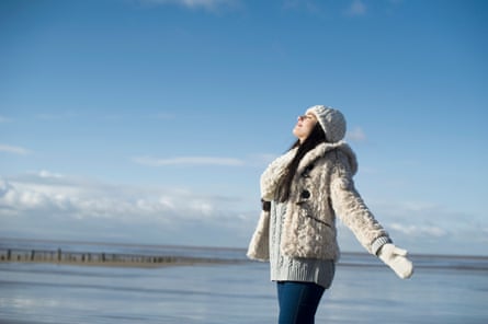 Young woman with arms out, Brean Sands, Somerset, EnglandPosed by model Breathing fresh air at the beach GettyImages-480812475