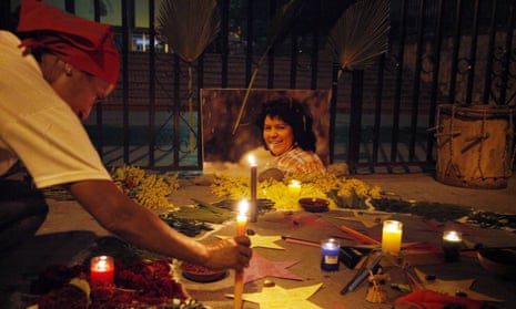 A woman places a candle in front of a picture Berta Cáceres outside the Supreme Court in Tegucigalpa, Honduras on 16 September. 
