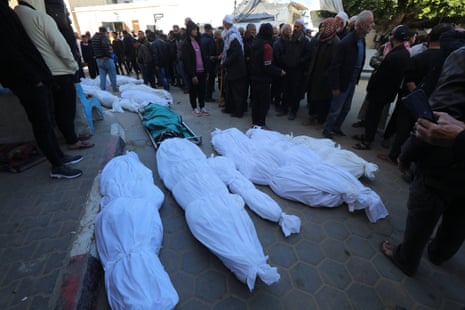Relatives of Palestinians killed in Israeli attacks mourn as they receive the dead bodies from the morgue of Al-Aqsa hospital, Dair el-Balah on 12 March.