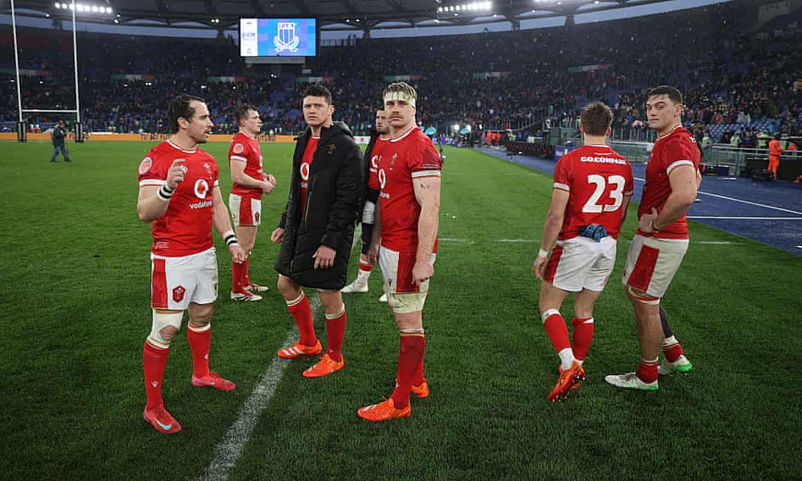 Rhodri Williams, James Botham and Aaron Wainwright of Wales on the pitch at full time