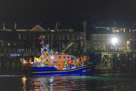 A group of people thought to be migrants are brought in to a marina in Gosport by the RNLI.