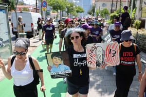 people march holding signs