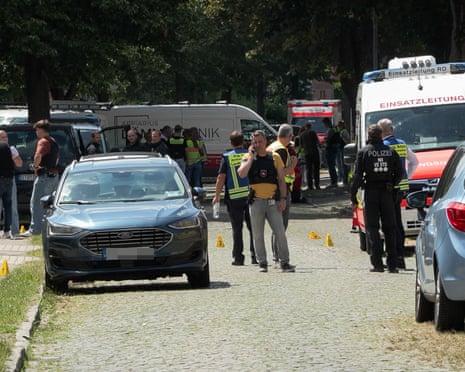 Police and rescuers work at the scene where several people were killed in a shooting in Stade, northern Germany.
