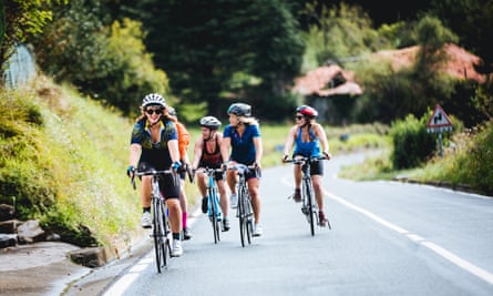 A group of female cyclists go uphill on the border between France and Spain.