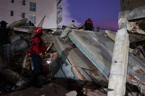 Members of the fire department rescue a person in Caracas
