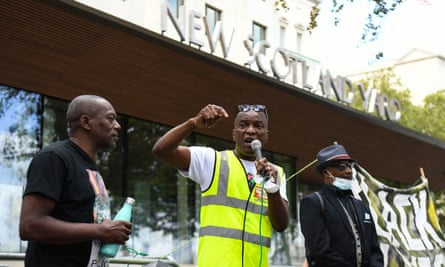 Stafford Scott (centre) speaks outside New Scotland Yard in London, as part of an anti-racism demonstration calling for Metropolitan police commissioner Cressida Dick to resign.