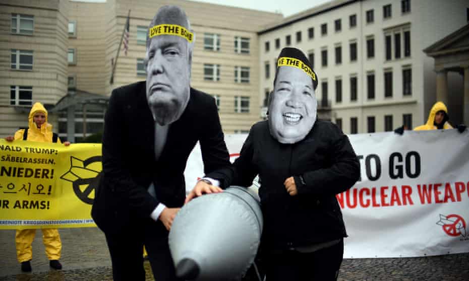 Activists of the non-governmental organization “International Campaign to Abolish Nuclear Weapons (ICAN)“ wear masks of US President Donal Trump and leader of the Democratic People’s Republic of Korea Kim Jon-un while posing with a mock missile in front of the embassy of Democratic People’s Republic of Korea in Berlin, on September 13, 2017. / AFP PHOTO / dpa / Britta Pedersen / Germany OUTBRITTA PEDERSEN/AFP/Getty Images