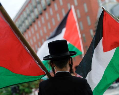 A man carries a Palestinian flag during a protest near the White House, as Israeli Benjamin Netanyahu meets with Donald Trump.