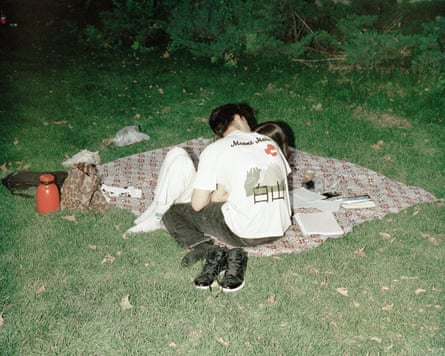 A young couple share a kiss while picnicking in Laleh Park