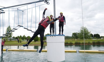 Sir Ed Davey falls as he attempts an Aqua Jungle floating assault course in Henley-in-Arden, Warwickshire.