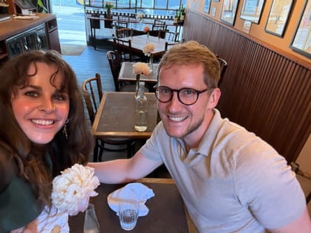 Andy and Imogen sitting smiling at a restaurant table on their date