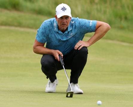 Henrik Stenson kneels to line up a putt on the 17th green during the third day of the Open