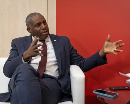 David Lammy interviewed on a sofa, gesturing with hands held wide