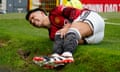 Manchester United’s Lisandro Martínez grimaces in pain after sustaining an injury in February.