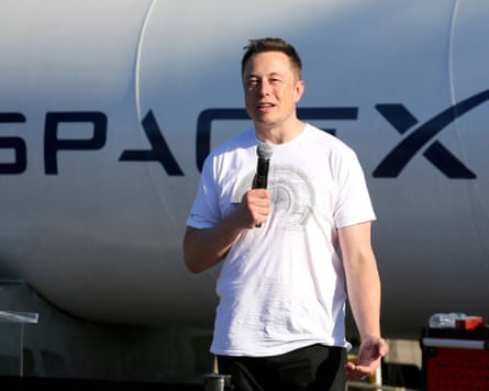 person wearing white shirt speaks into microphone