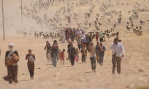 Displaced Yazidis from Sinjar fleeing Isis walk towards the Syrian border, August 2014