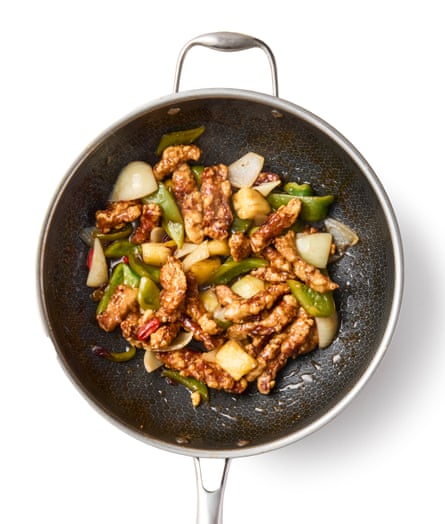 Heat the same pork oil to 190C and fry the meat again, this time for just 30 seconds, until golden brown. Scoop out with a slotted spoon and transfer to the sauce. Turn up the heat, toss to combine.
