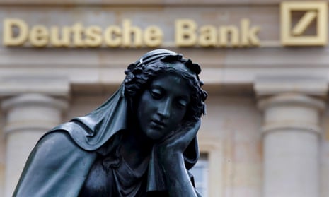 A statue looking sad next to the Deutsche Bank logo