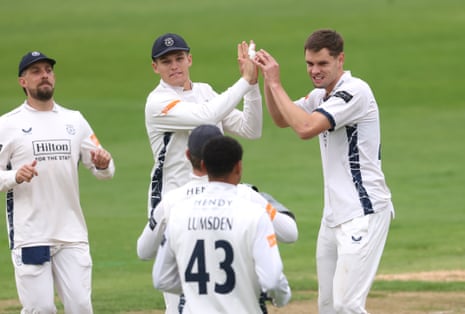 Scott Currie of Hampshire celebrates with teammates after taking the wicket of Ben Slater at Trent Bridge