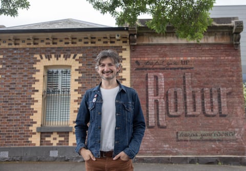 Sean Reynolds, founder of the Instagram account @melbourne_ghostsigns. He is in front of one of his favourite Robur Tea signs, on a wall in Carlton North.
