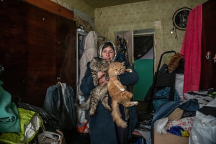 Tetiana Martynova, 60, lives with her four cats, two dogs and a rabbit in the rubble of what is left of her home