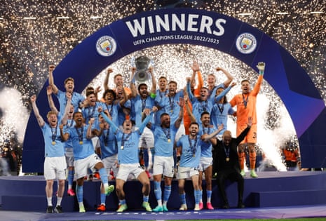 Manchester City’s players celebrate with the Champions League trophy