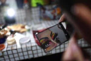 An LGBTQ member prepares before a streamed performance of “Pride at Home,” at the National Theatre. To celebrate 20 years of gay pride in Venezuela, LGBTQ members organised a presentation of different artistic shows via live streaming amid the new coronavirus pandemic