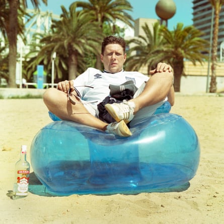 Shaun Ryder sitting on an inflatable chair on a beach