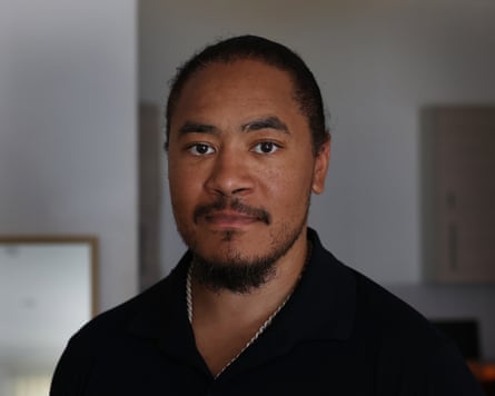 A headshot of Rob Lewis, who is 36, wearing a black top and looking at the camera