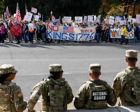 National guard officers watch a No Kings protest