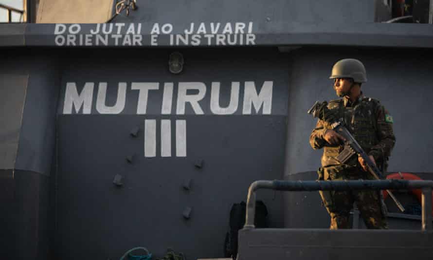 A solider navigates the Itaguaí river.