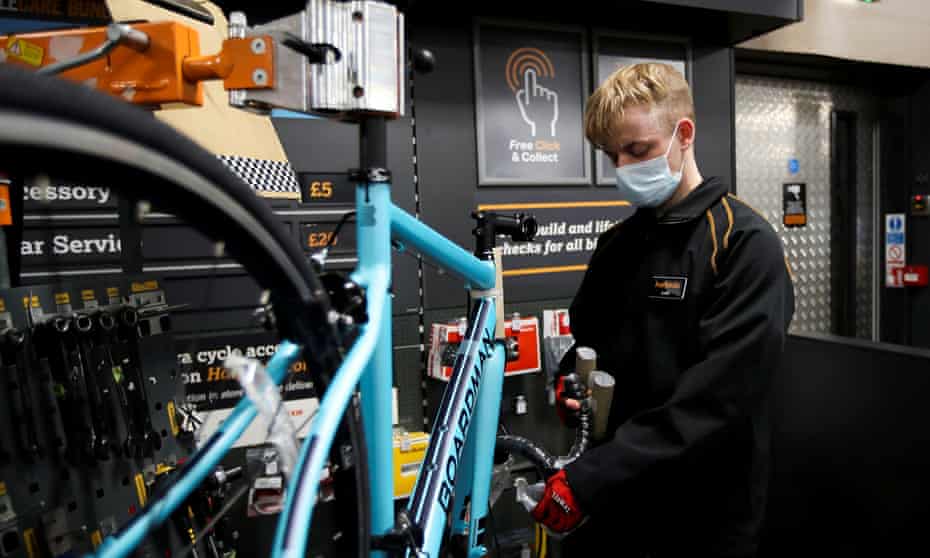 A member of staff works on a bike at Halfords in Rugby