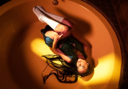 TSHA lying fully clothed in a bath