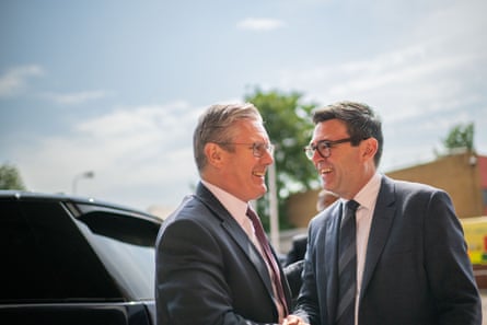 Starmer and Burnham greet, smiling