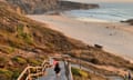 A little girl runs down decking towards Praia do Malhão beach on Portugal’s Alentejo coast.