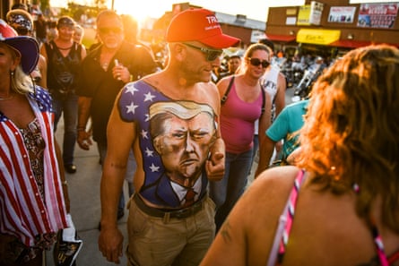 Johne Riley shows off his chest painted with a portrait of Donald Trump during the 80th annual Sturgis motorcycle rally on 7 August 2020 in Sturgis, South Dakota, which usually attracts around 500,000 people.