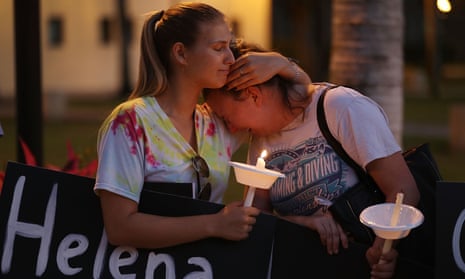 Two women attend a vigil in Boca Raton, Florida, on 16 February for the 17 people killed at a school shooting at Marjory Stoneman Douglas high school. 