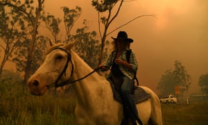 Woman evacuating fire on horseback
