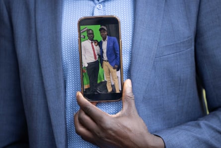 Lual Akech, the father of the murder victim Aguer Akech, with a photograph of his son.