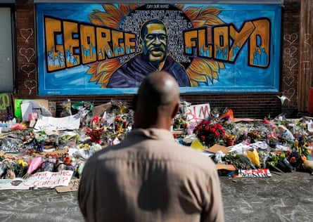 A local resident stands in front of a makeshift memorial honoring George Floyd in Minneapolis, Minnesota.