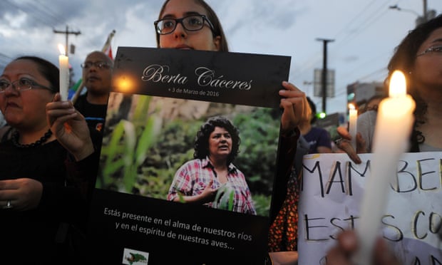 A woman holds a portrait of Berta Cáceres Flores in Tegucigalpa in March.
