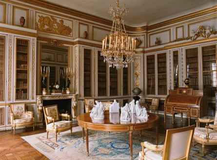 A grand library covered in gold leaf, decorated with Greco-Roman imagery