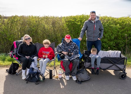Family sit on chairs near the airbase